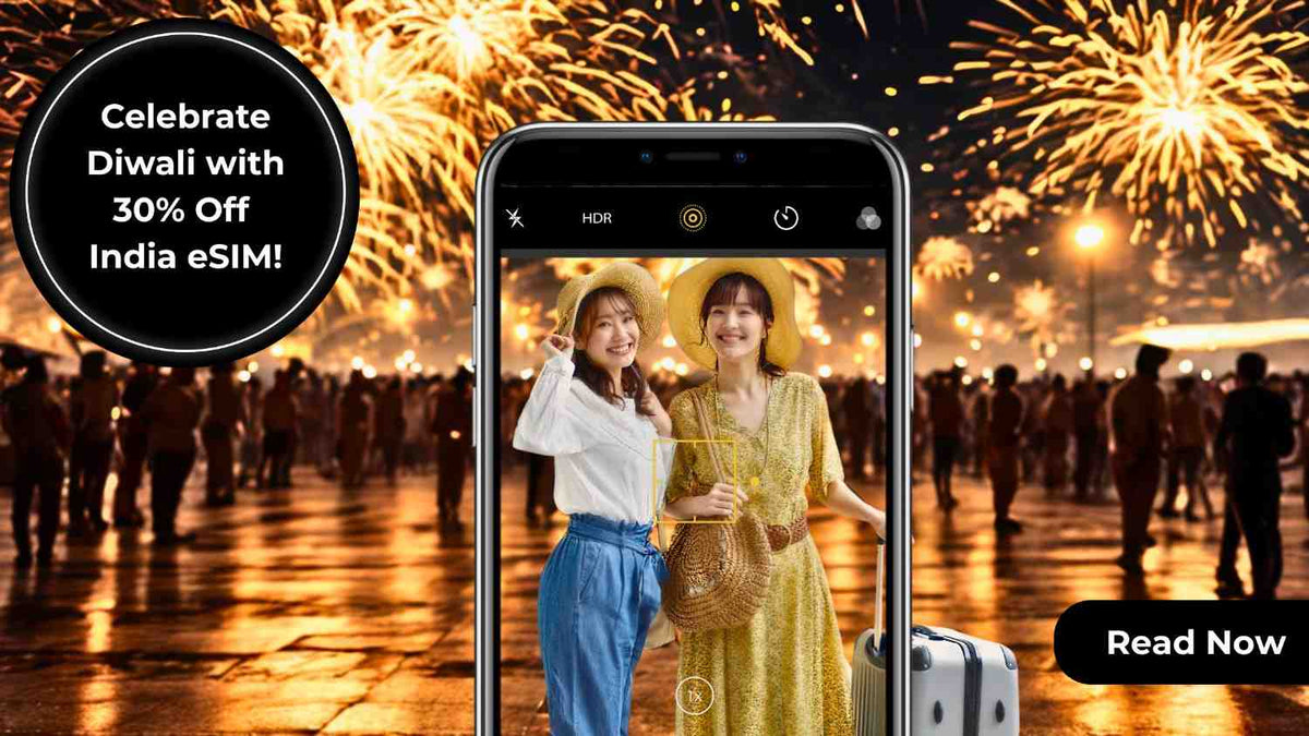 India eSIM Diwali promotion: Two smiling tourists photographed on a phone with fireworks in the background.